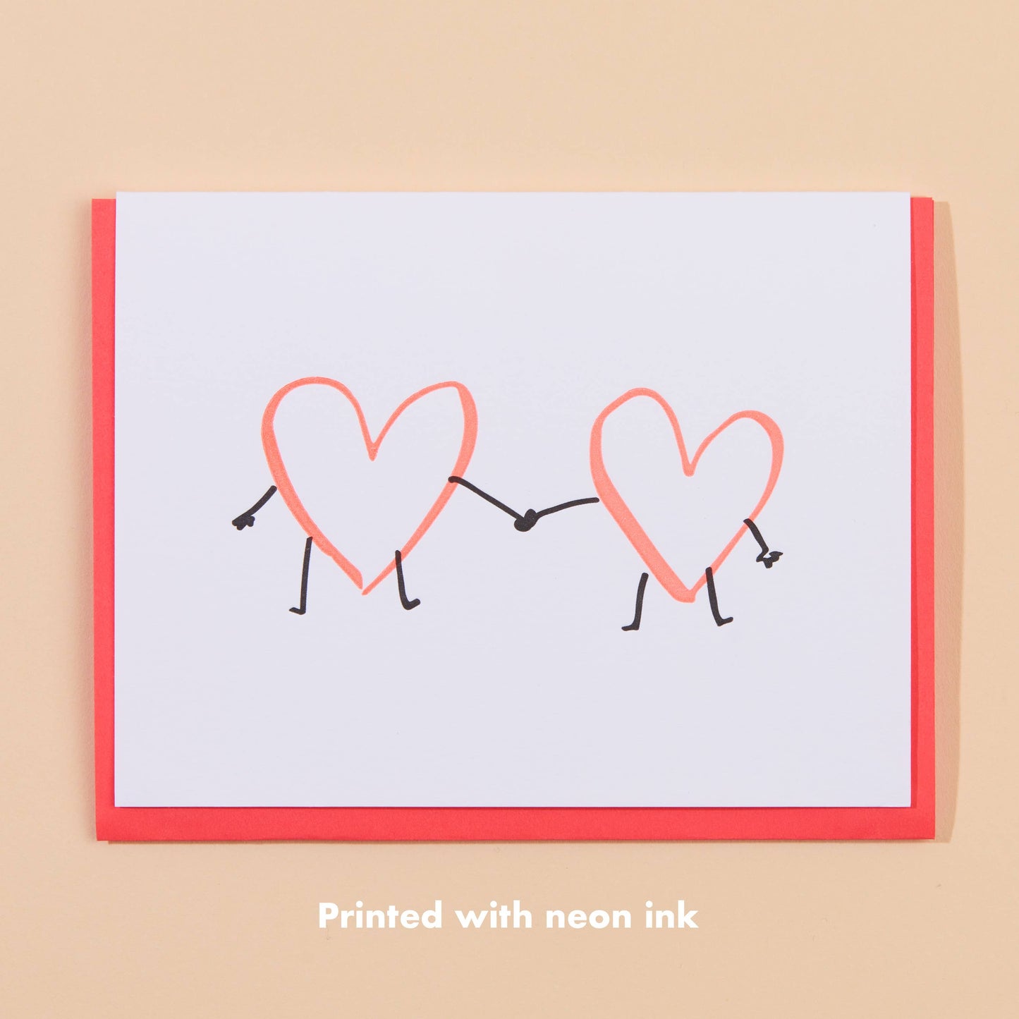 greeting card with two hearts holding hands