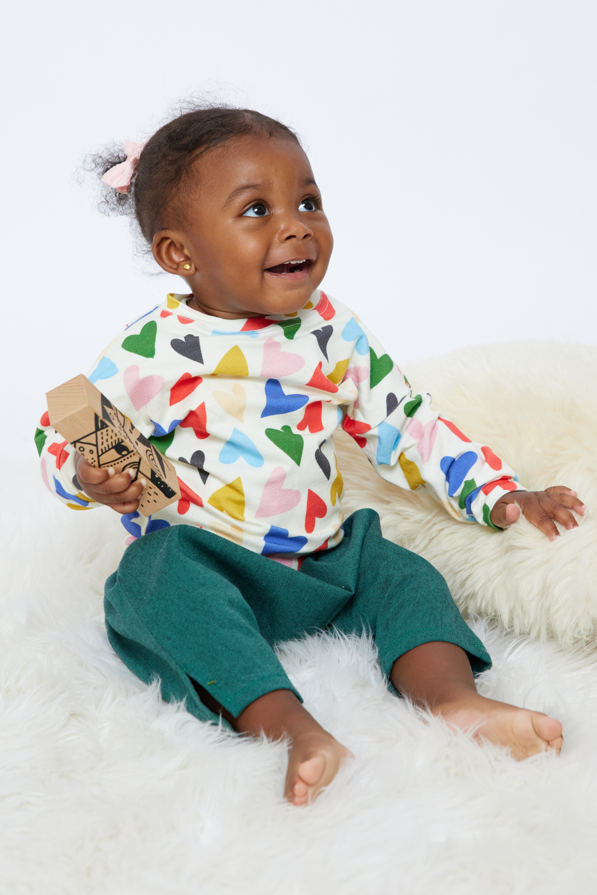 baby smiling and sitting wearing cotton/bamboo baby pants